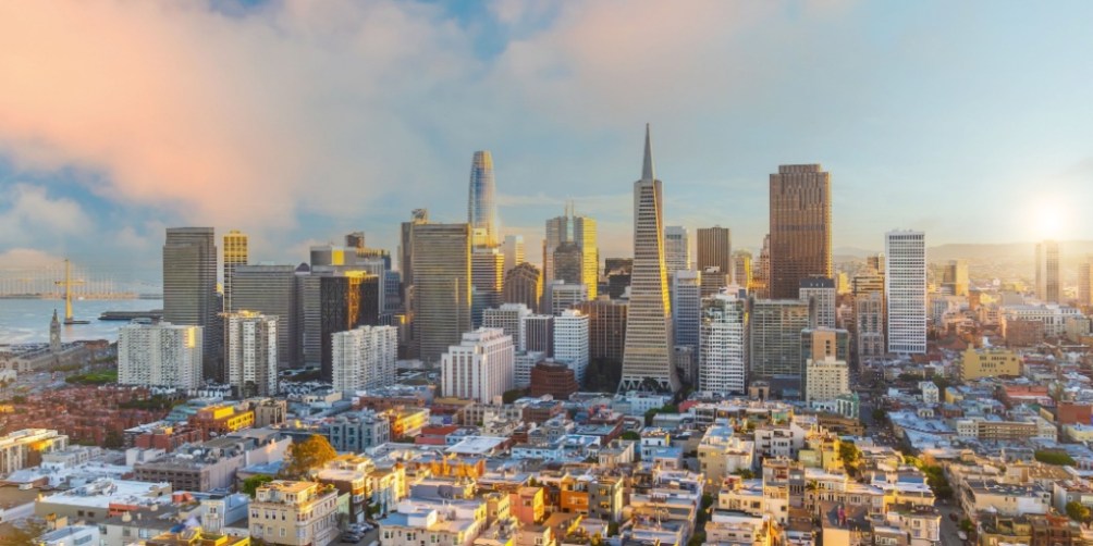 San Francisco skyline at sunset with residential neighborhoods in the foreground, representing renters insurance in California and protection for city apartment living.