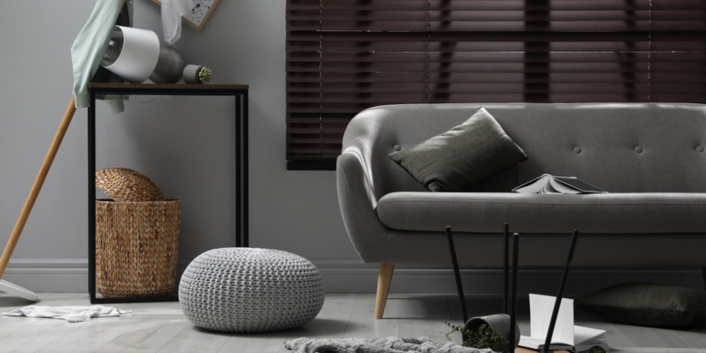 Disorganized living room with overturned furniture and decor, demonstrating how renters insurance covers property damage from accidents or vandalism.