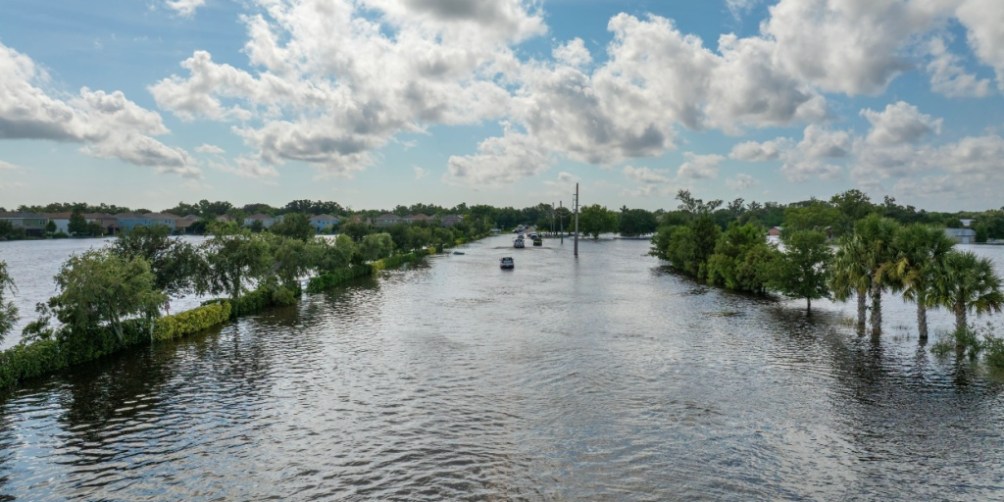 A flooded residential street in the aftermath of a hurricane, highlighting the importance of renters insurance coverage for hurricane damage.