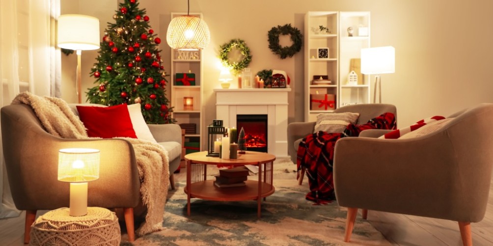 Warm, decorated living room with Christmas tree and candles, showcasing best practices for holiday safety around lights and seasonal decorations.