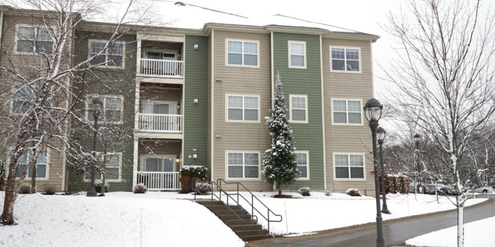 “Apartment complex blanketed in snow after a storm, emphasizing safety planning and how to prepare for a winter storm in an apartment.