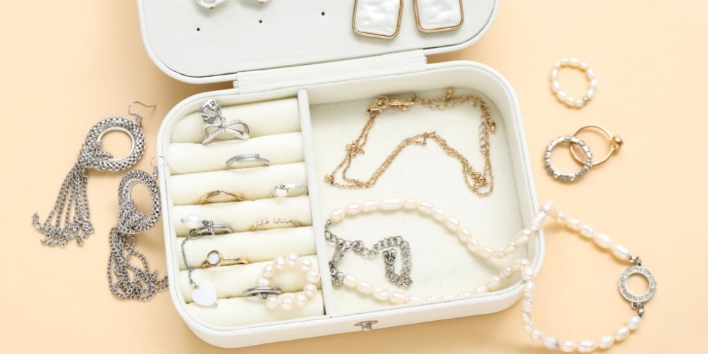Open jewelry box filled with rings, necklaces, and earrings, representing valuable possessions that require high-value item coverage.