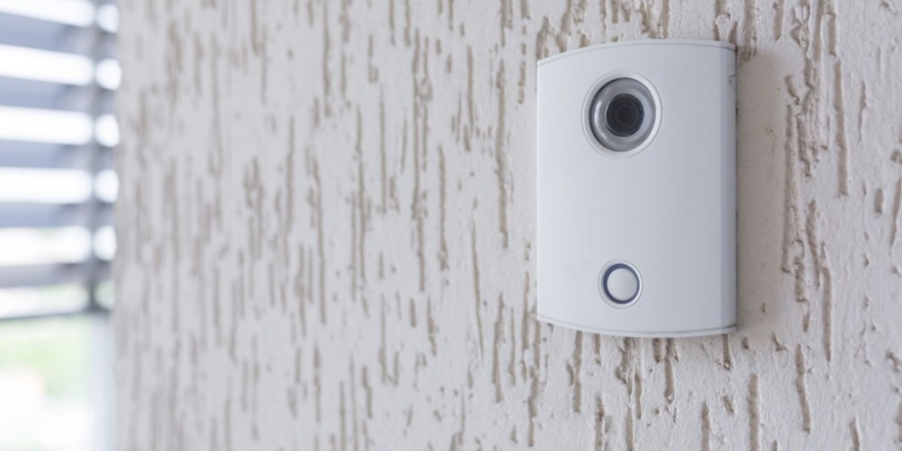 Wall-mounted smart door camera used as one of many modern safety gadgets to monitor visitors and enhance apartment security.