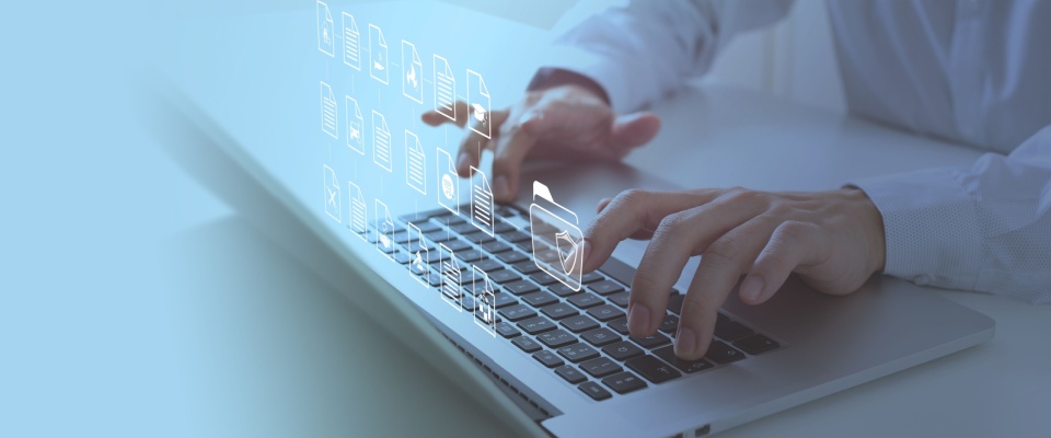 Close-up of hands typing on a laptop keyboard with floating digital folder and document icons, illustrating the importance of renters insurance and understanding deductibles.