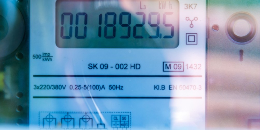 A close-up shot of a digital smart electricity meter installed on a modern home wall.