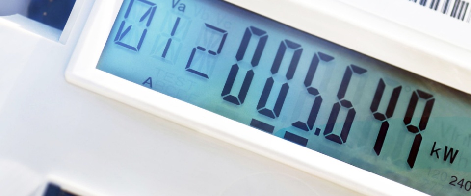 A close-up of a electric smart meter displaying kilowatt usage, visually illustrating how electricity works.