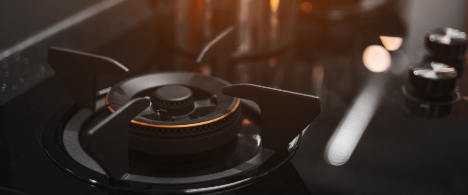 Close-up of a lit gas stove burner representing home safety and the protection that proof of renters insurance provides against fire damage.