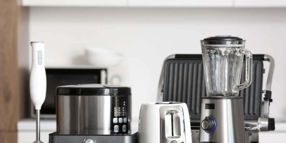 Various kitchen appliances including a blender, toaster, and slow cooker on a countertop, illustrating renters insurance coverage for appliance repairs.
