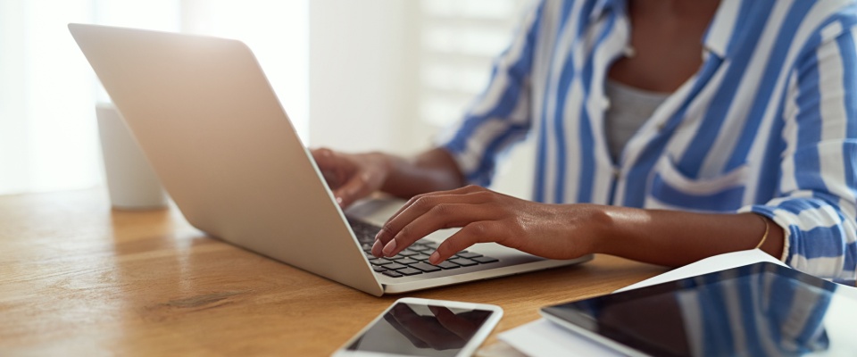 Person researching housing and financial options online to understand how renters insurance covers displacement after an emergency.