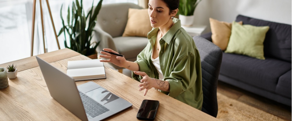 Woman working on a laptop at home office researching whether renters insurance is tax deductible for self-employed or remote workers.